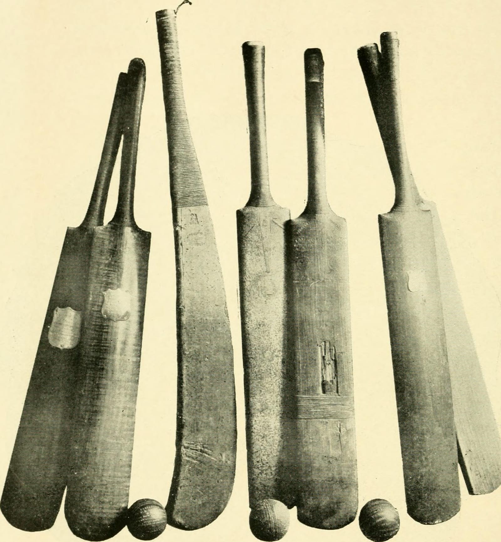 Historic cricket bats and balls laid out together